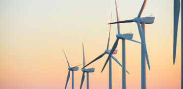 Wind turbine generators at dawn for clean electricity production.