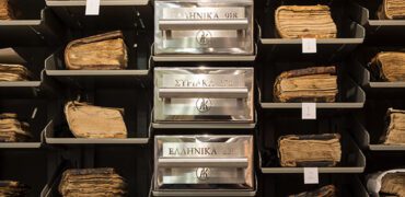 A row of manuscripts and cases in storage
