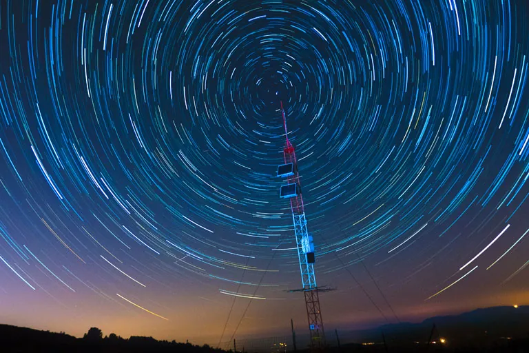 A satellite comms tower under a starry sky – solar storms could potentially disable communications across the entire planet.