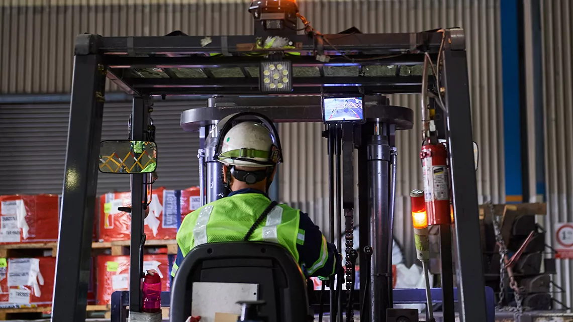 Ternium steel worker driving a forklift